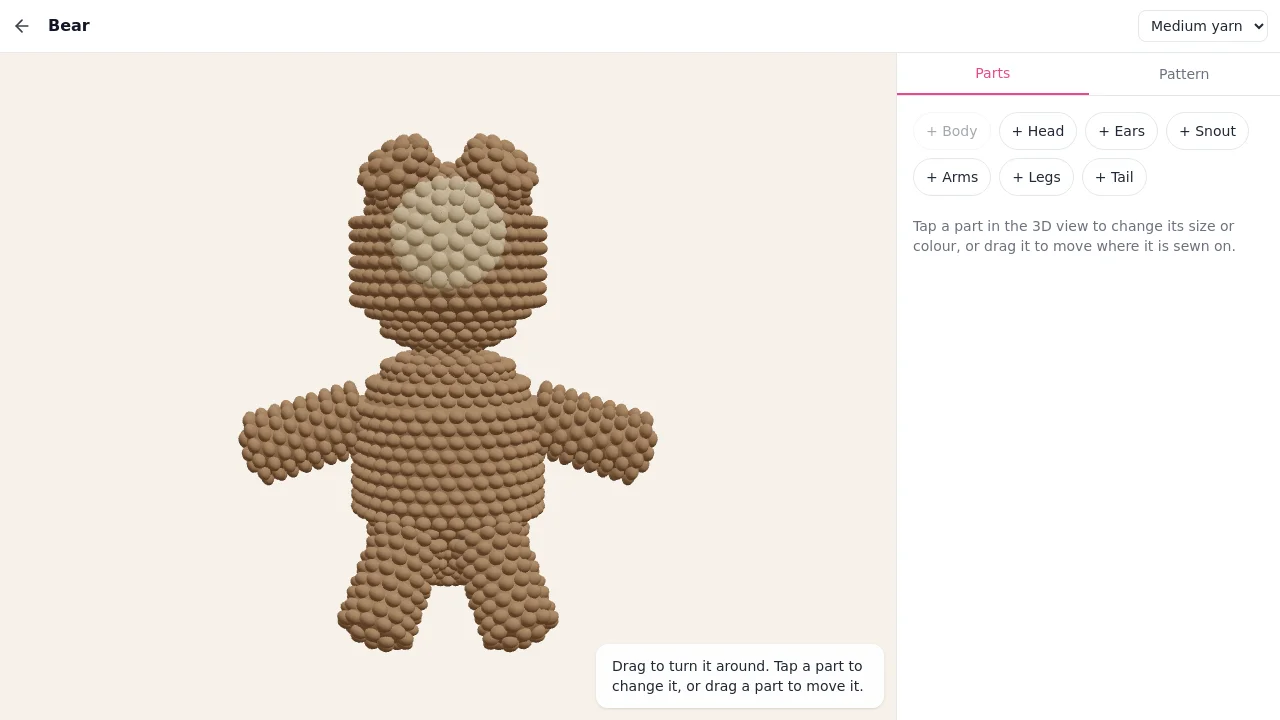 The amigurumi designer with a crocheted bear in the 3D view and the parts tray beside it